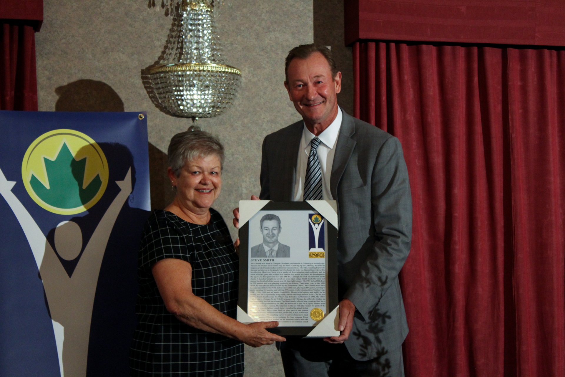 Steve Smith receives certificate from Liz Basinger