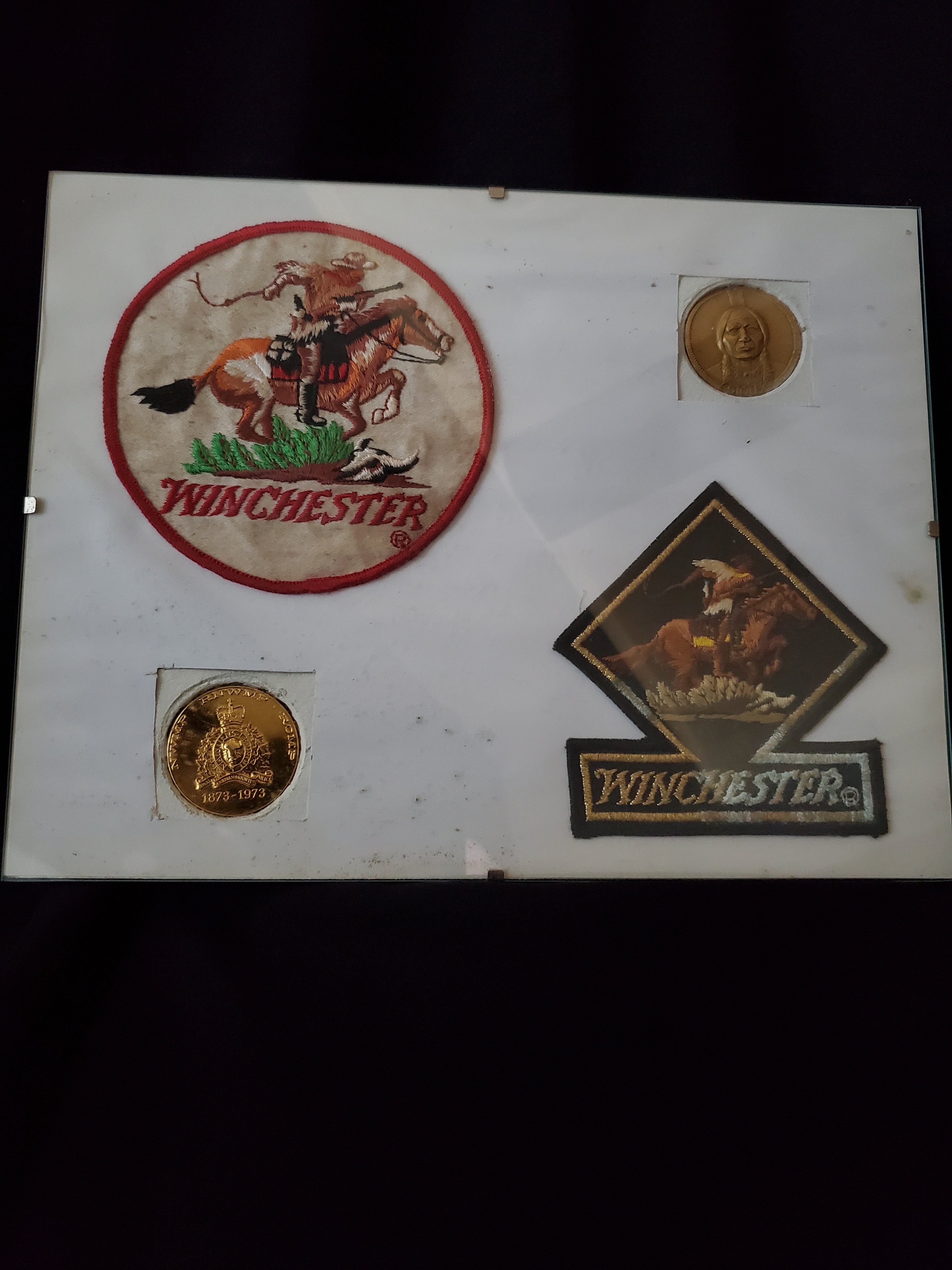 Winchester items on pressboard-2 crests & 2 inlays
