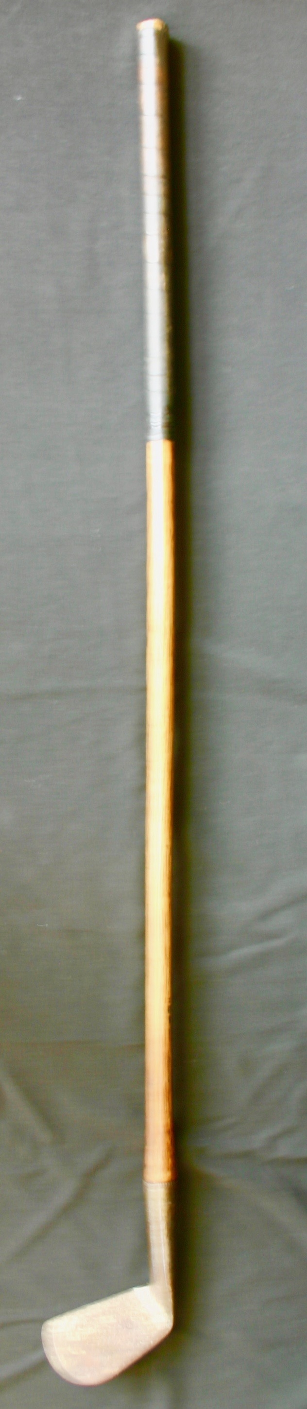 Golf club-metal head -wrapped wooden shaft
