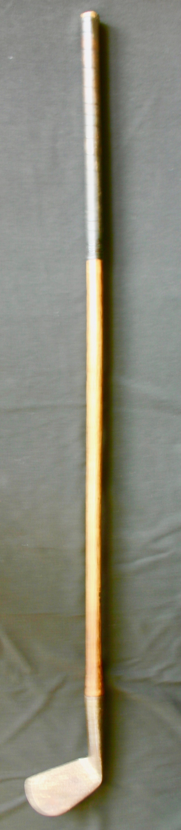 Golf club-metal head -wrapped wooden shaft