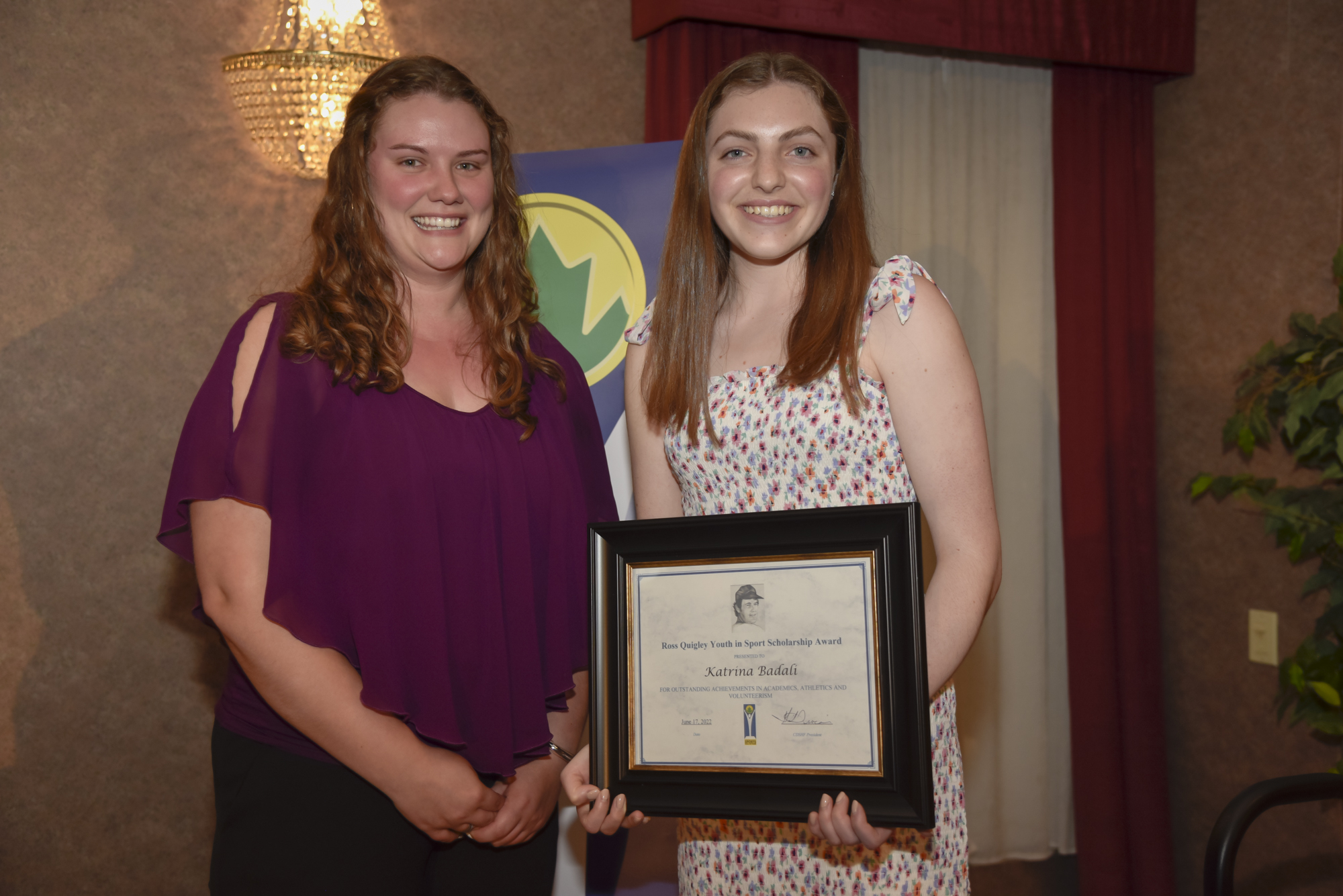 Katrina Badali receives Award certificate from Kaitlyn DeJong