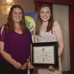 Katrina Badali receives Award certificate from Kaitlyn DeJong