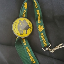 Cobourg Cougars metal button with green lanyard